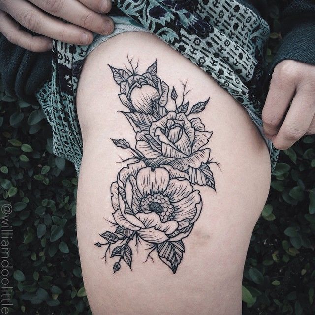 a woman's thigh with flowers on it