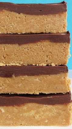 four pieces of peanut butter bars stacked on top of each other