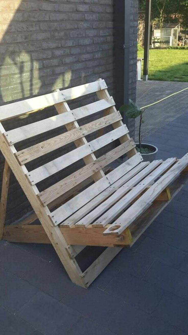 a wooden chair sitting on top of a sidewalk