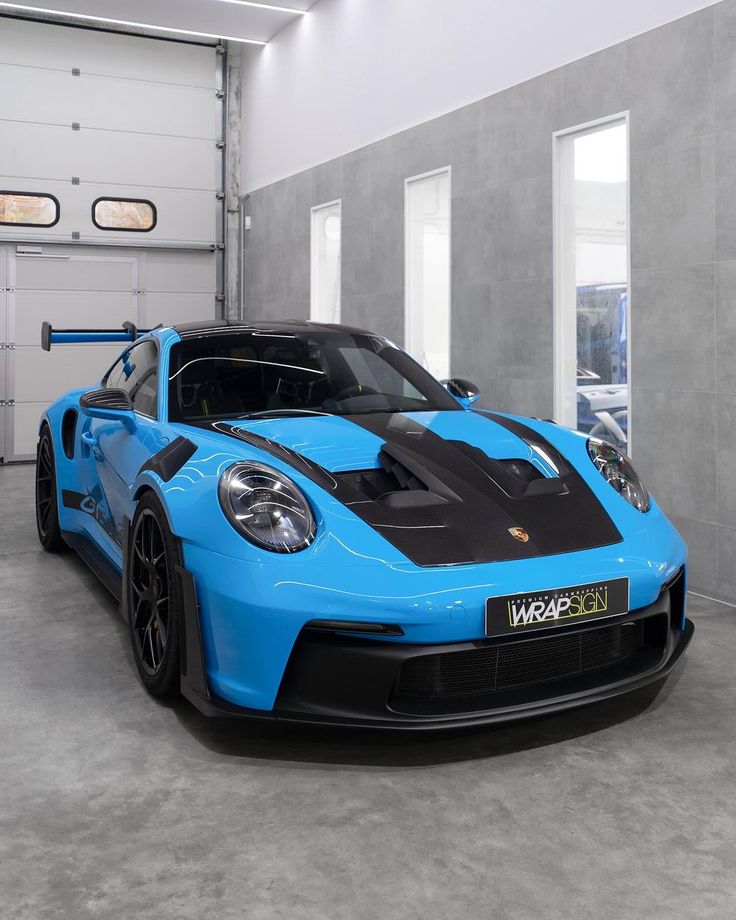 a blue sports car parked in a garage