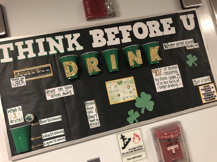 a bulletin board with st patrick's day signs and shamrocks on the wall