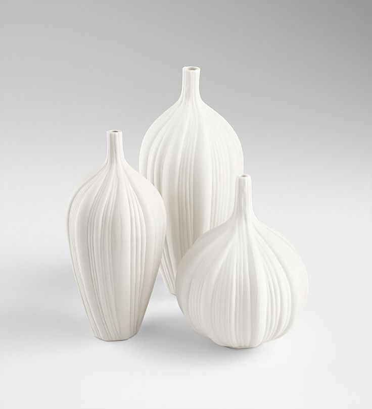 three white vases sitting next to each other