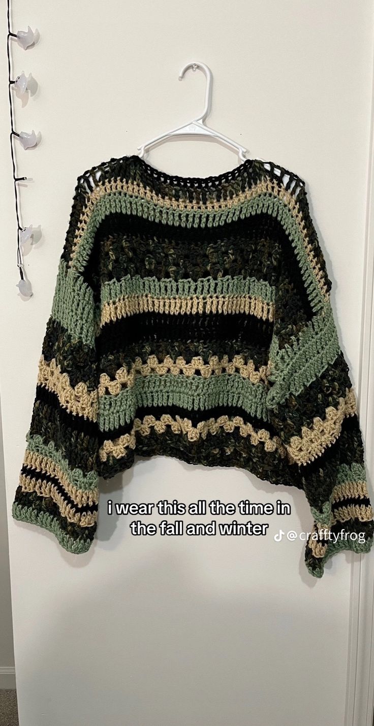 a crocheted sweater hanging on a door with the words, i have this pattern written below it