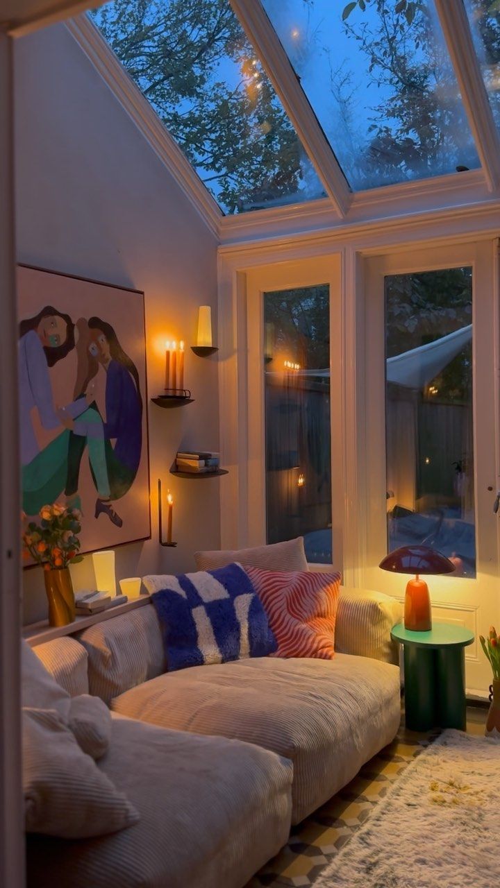 a living room filled with furniture under a skylight