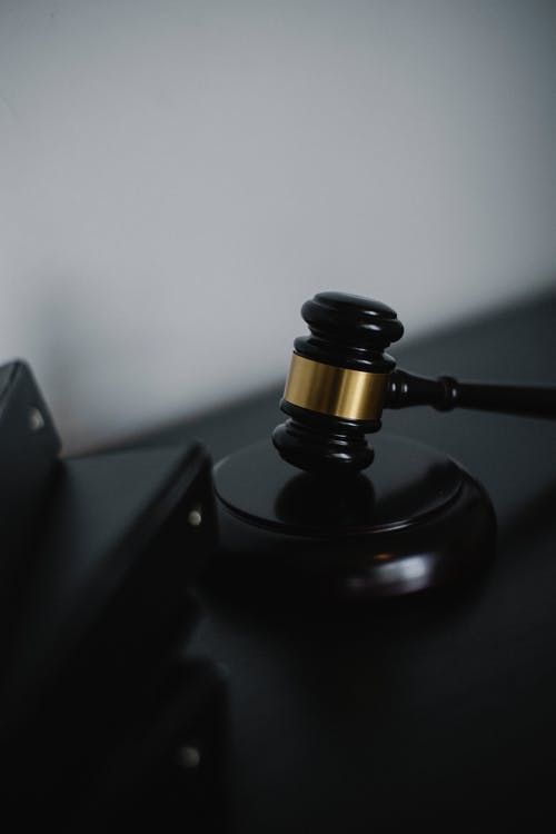 a wooden judge's gaven sitting on top of a black table