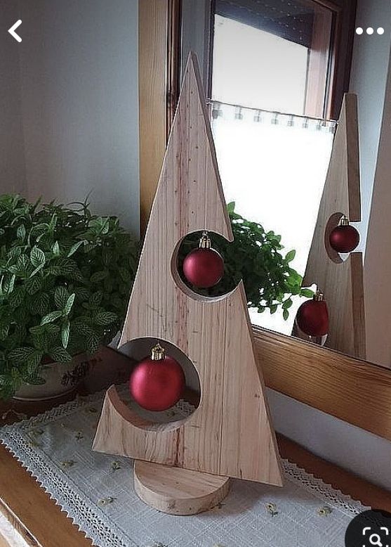 a wooden christmas tree with red ornaments on it