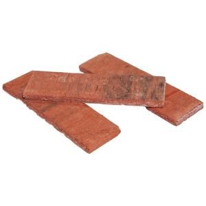 two pieces of red brick sitting on top of each other