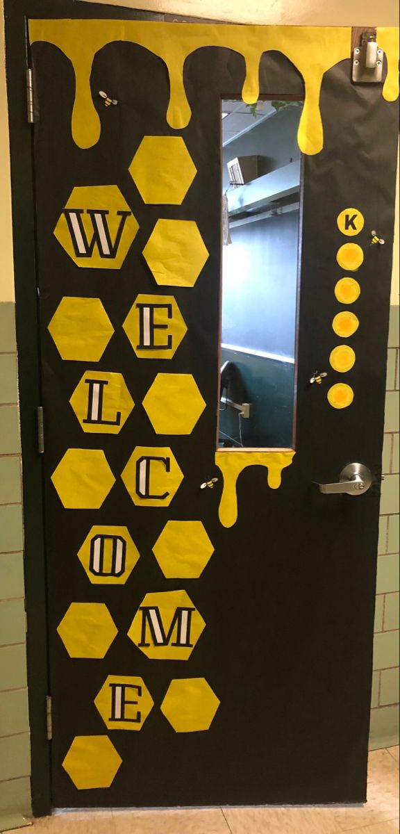 Honeycomb and honeybee decorated classroom door with welcome sign. Honey Bee Decor Diy Porch, Bee Library Bulletin Board, Classroom Door Bee Theme, Bee Hive Classroom Door, Bumble Bee Classroom Door, Bee Hive Door Decoration, Bee Themed Office, Library Bee Theme, Bee Themed Room Decor