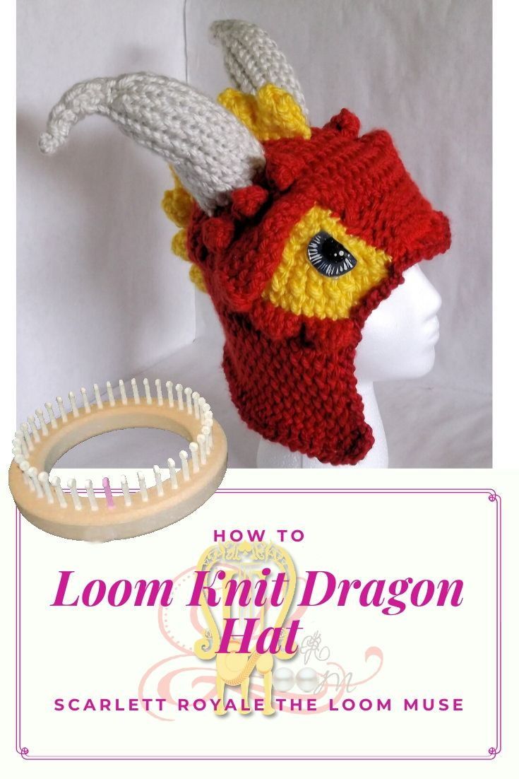 a knitted dragon hat with horns on it and a comb in the foreground