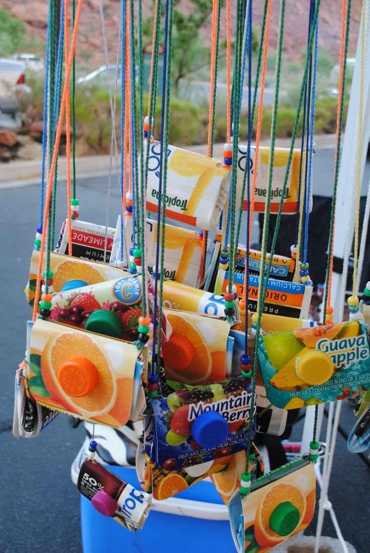 an assortment of fruit and candy hanging from strings