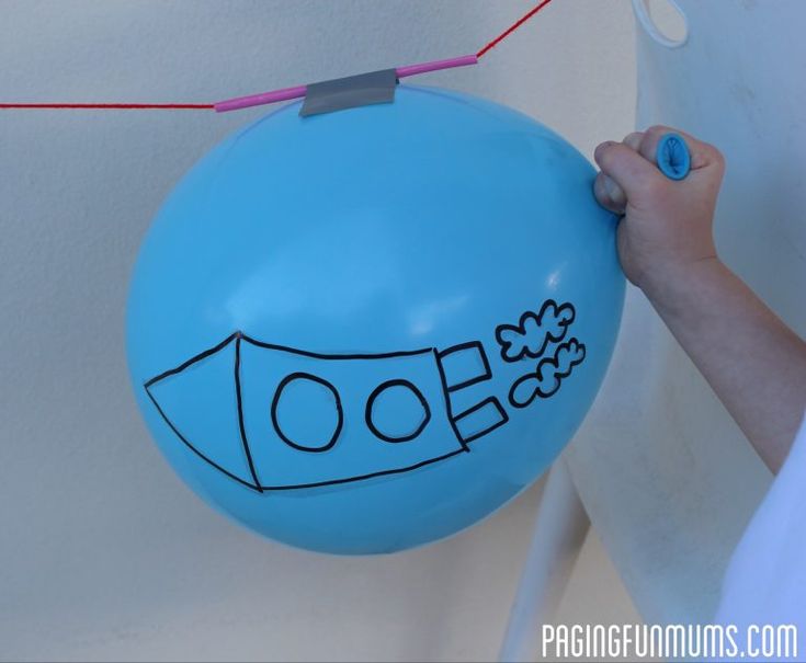 a person holding a blue balloon with the word doo written on it