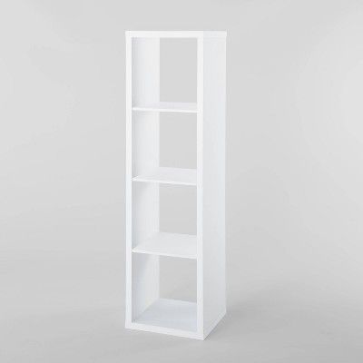 a white bookcase with three shelves on the bottom and one shelf in the middle