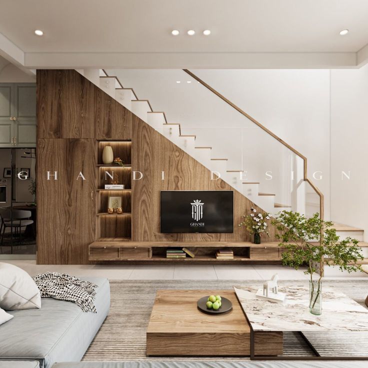 a living room filled with furniture and a flat screen tv sitting on top of a wooden shelf