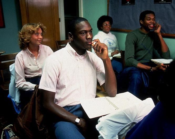 a group of people sitting around each other talking on cell phones