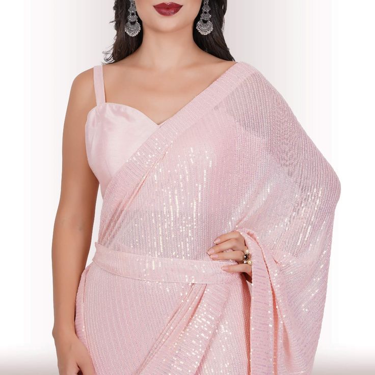 Are you ready to shine? Elevate your style with our Ready-Made Sequin Saree in the enchanting Blush shade. Crafted from high-quality georgette fabric adorned with mesmerizing sequin work, this saree promises a lavish and effortless style upgrade. It effortlessly drapes in less than a minute, ensuring you're ready to dazzle in no time! 🤩😍💃With its exquisite design and easy-to-wear nature, this Ready-Made Sequin Saree makes a statement without the need for elaborate draping or styling. The sequ