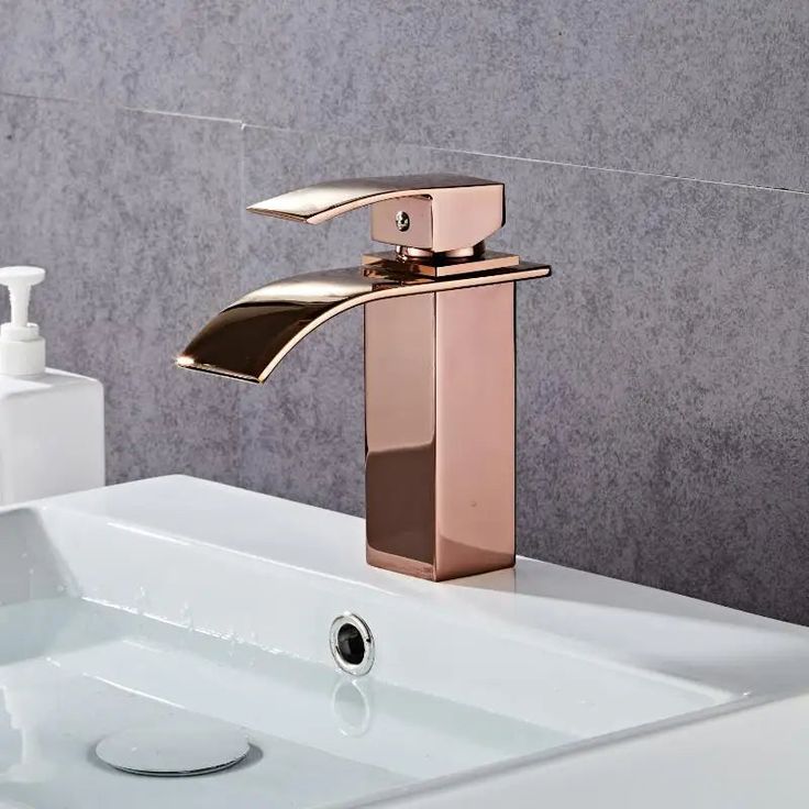 a bathroom sink with a faucet and soap dispenser