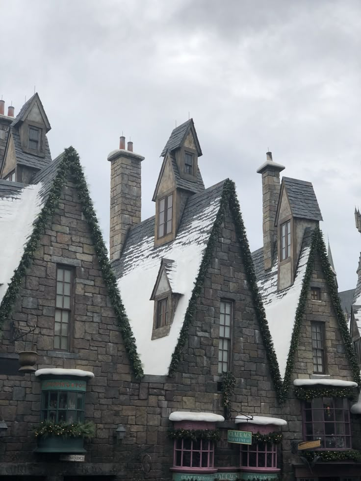 an old building with ivy growing on it's roof and windows in the snow