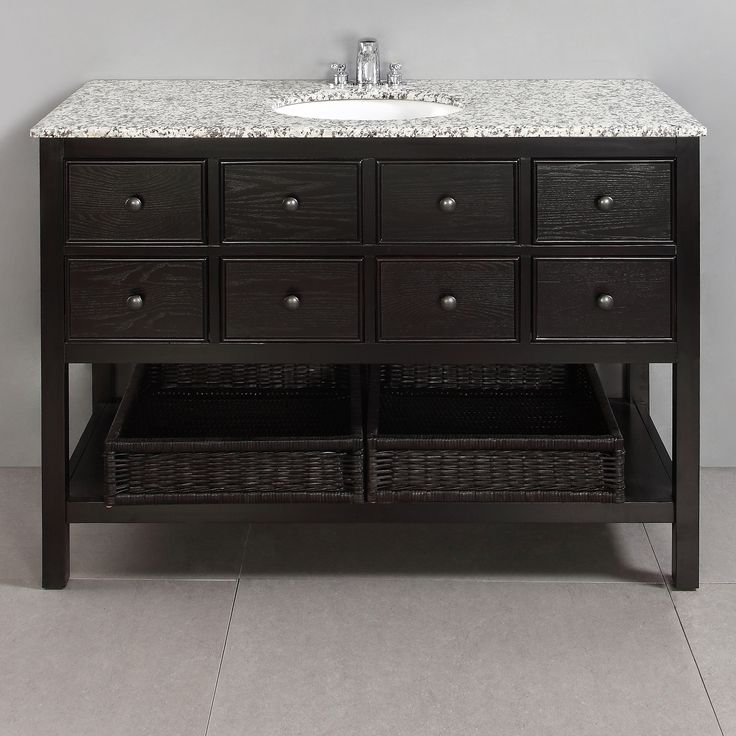 a bathroom vanity with marble top and drawers