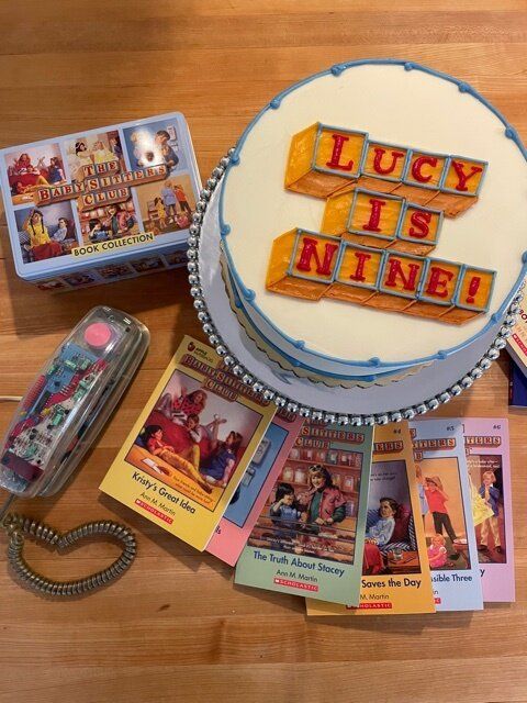 there is a cake with the words lucky is nine on it and other items surrounding it