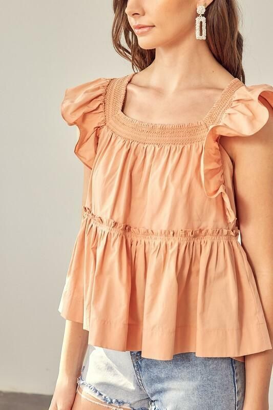 Final Sale - Get it before it's gone! Beautiful weather calls for the Dani Apricot Ruffle Babydoll Top! This flowy, woven top has a square neckline, short ruffle sleeves, and a wide-cut bodice. A relaxed silhouette features a ruffled trim drop seam tier with a ruffle hem. Tassel tie back finishes the look. Pair with your favorite shorts for a cute warm-weather look! DETAILS & CARE Cotton. Machine wash cold. Imported. Summer Smocked Top With Ruffle Hem And Short Sleeves, Spring Smocked Top With Square Neck, Cute Cotton Square Neck Tops, Summer Cotton Smocked Puff Sleeve Top, Spring Smocked Top With Ruffled Straps And Details, Summer Cotton Smocked Top With Puff Sleeves, Spring Smocked Top With Ruffles And Ruffled Straps, Flowy Smocked Top With Puff Sleeves For Summer, Flowy Puff Sleeve Smocked Top For Summer