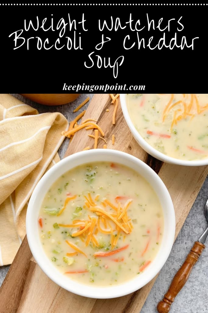 two bowls of broccoli cheese soup on a cutting board