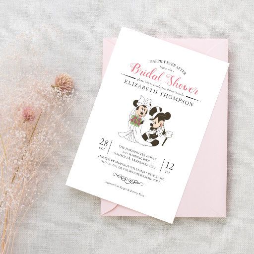 a pink and white wedding card with mickey and minnie mouse on it next to some dried flowers