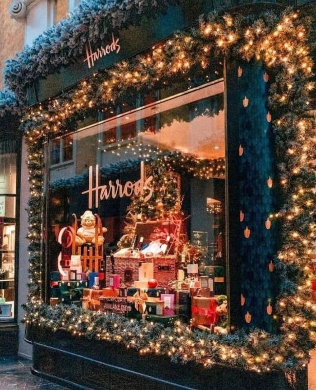 a store front with christmas lights and decorations on the windows display it's holiday spirit