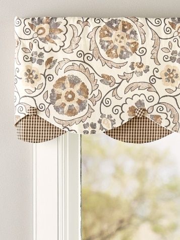 the window is decorated with an intricate pattern and has a valance made from fabric