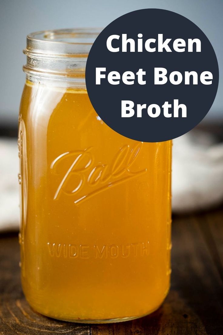 chicken feet bone broth in a mason jar on a wooden table with text overlay that reads chicken feet bone broth