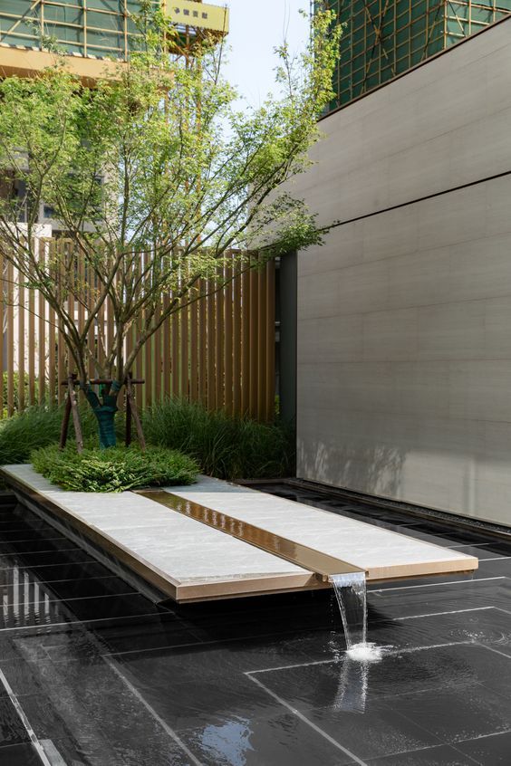 a water fountain in the middle of a courtyard