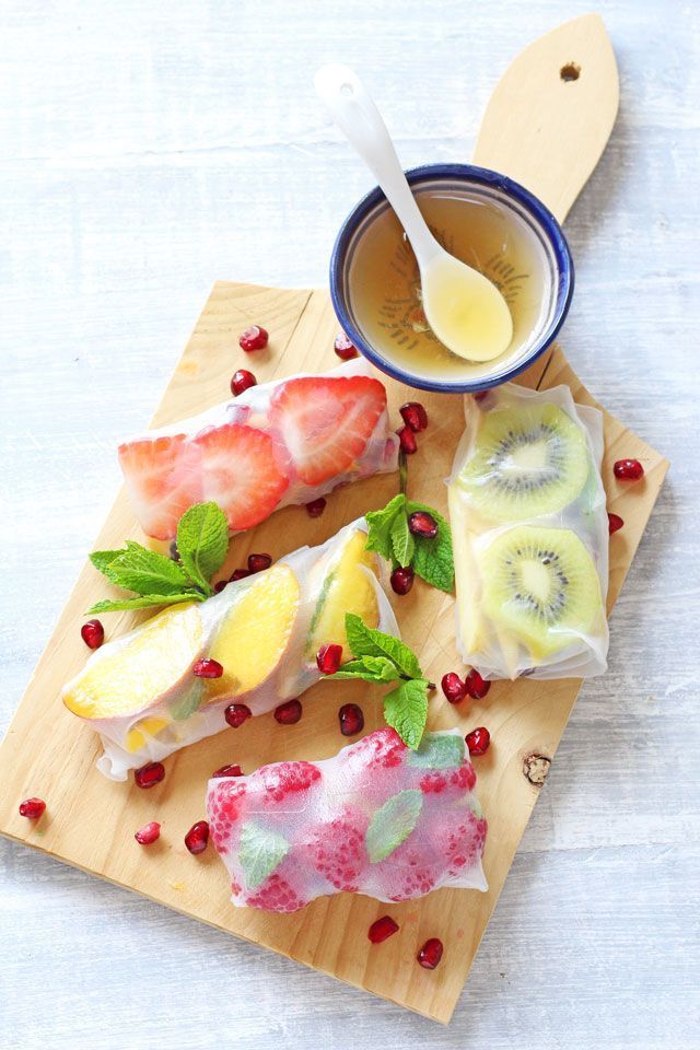 some fruit and yogurt are on a cutting board