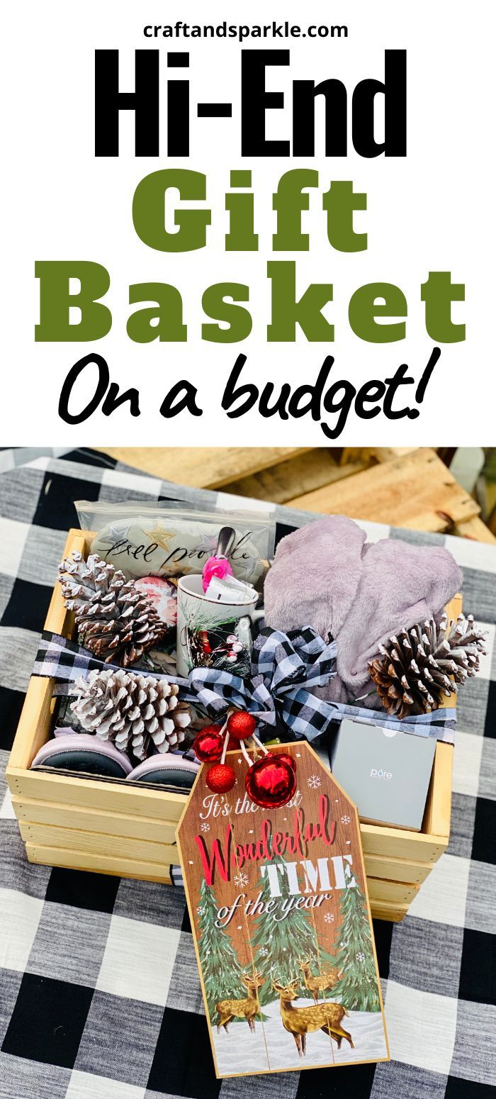 an open gift basket on a table with pine cones and other holiday items in it