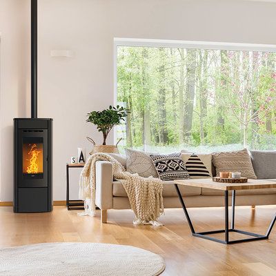 a living room filled with furniture and a fire place in the middle of it's wall