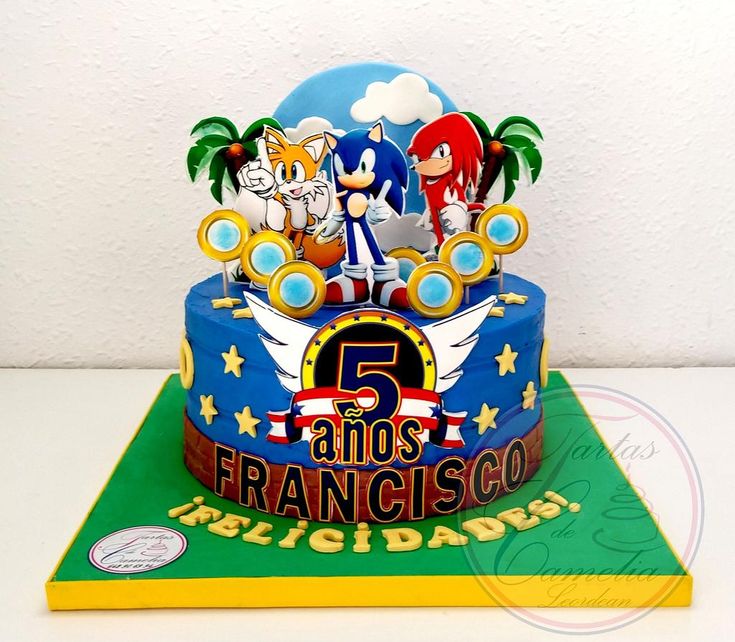 a birthday cake with sonic the hedgehog and friends on it's top tier