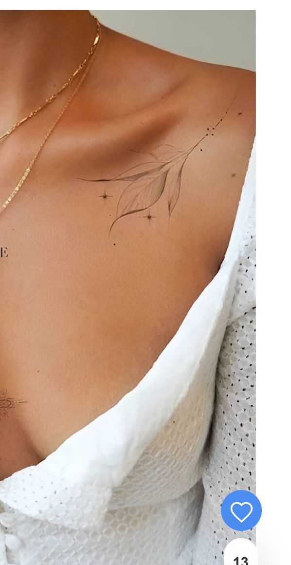 a woman's chest with an arrow tattoo on the left side of her chest