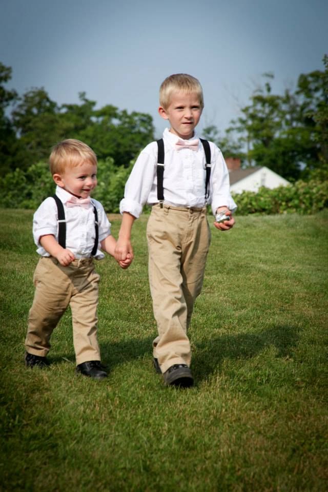 two young boys in formal clothes holding hands