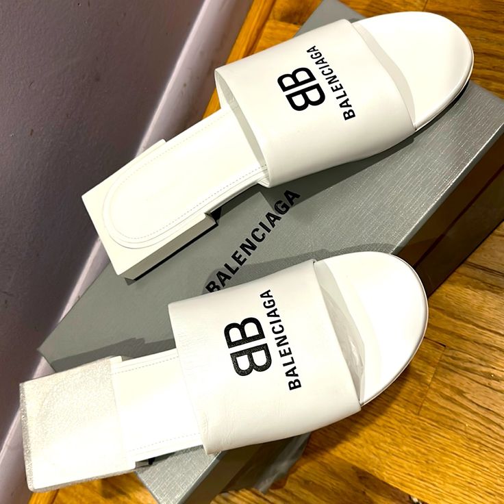 Balenciaga Box Sandals In Optical White Balenciaga Crocs Boots White, White Leather Sole Slides For Spring, White Slides With Leather Sole For Spring, White Slides With Leather Sole For Summer, White Leather Sole Slip-on Slides, Luxury White Leather Slides, White Leather Flat Heel Slides, White Leather Slides With Flat Heel, Luxury White Flat Heel Sandals