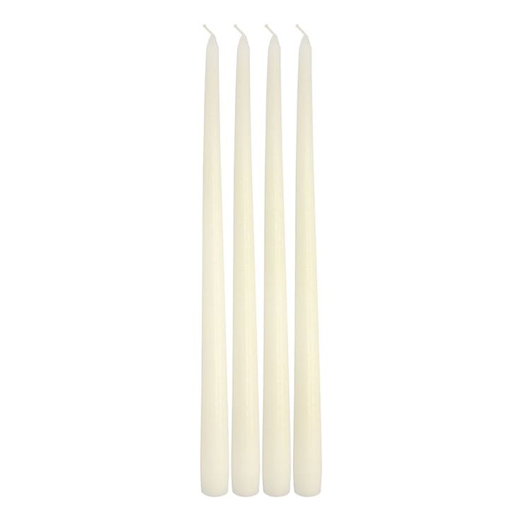 four white candles sitting next to each other