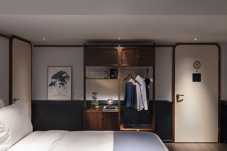 a bed sitting next to a closet in a bedroom