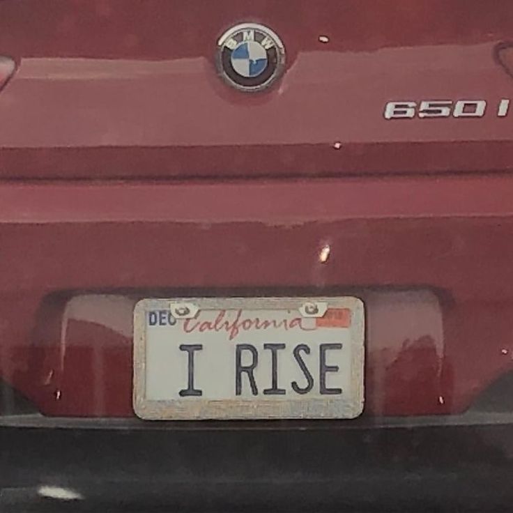 a license plate on the back of a red car