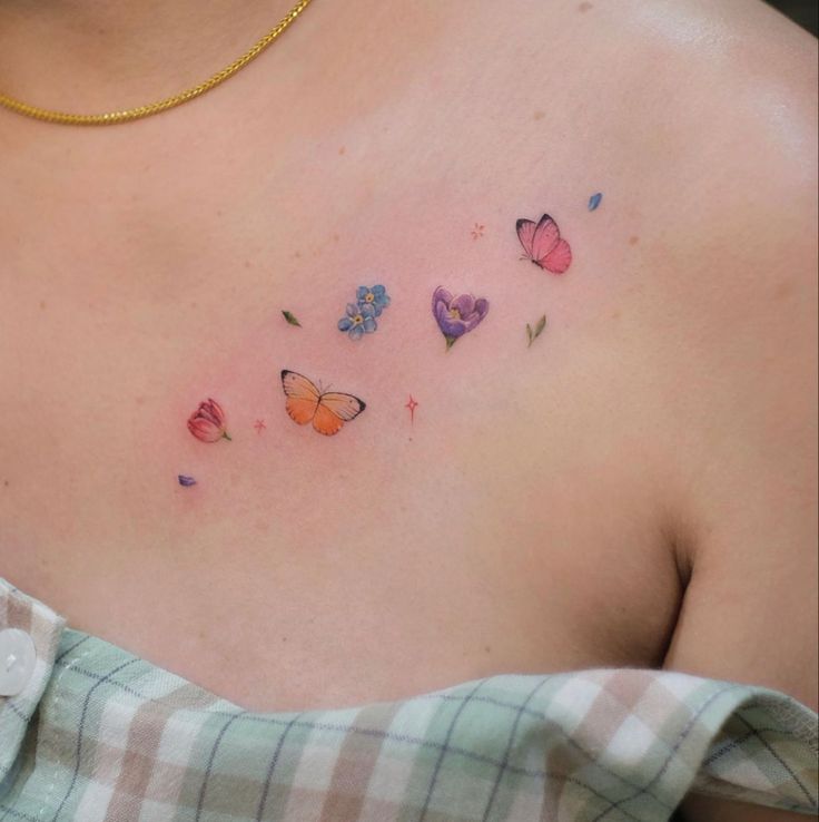 a woman's chest with colorful butterflies on it