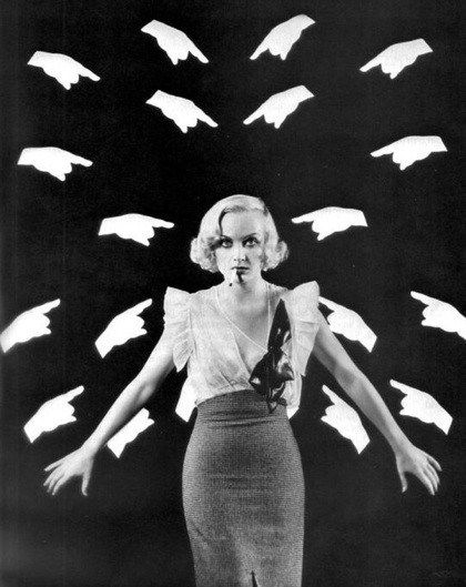 a black and white photo of a woman with her arms outstretched in front of flying birds