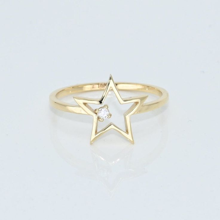 14k Solid Gold Dainty Star Ring, Real Gold Open Star Ring with premium grade D Color (colorless) VS/SI clarity moissanite.  💙 Our jewelry is handcrafted with love and great care at San Francisco Bay! All of our items are 14k stamped for authenticity. 💙 You will receive them exactly as pictured. We don't use any filters, all photos are authentic and unedited.   💙 Dimensions: Band thickness: 1.5 mm, Star: 12 mm. 💙 The ring material is 14k Solid gold, should not be confused with gold plating or filling. It won't tarnish or fade over time. 💙 We're offering the finest quality in solid gold jewelry. 💙 Quick shipping - Your order will be handcrafted and shipped in a few days. 🎁 They are delivered in a nice jewelry box, ready to be presented as a precious gift. 💎 Moissanite is the best alt Star-shaped Diamond Ring For Anniversary, Anniversary Star-shaped Diamond Ring, Fine Jewelry Star Shaped Rings For Gifts, Star-shaped Brilliant Cut Rings For Anniversary, Star-shaped Anniversary Ring With Brilliant Cut, Diamond Star Ring For Gift, Star-shaped 14k Gold Promise Ring, 14k Gold Star-shaped Promise Ring, 14k Gold Star-shaped Jewelry For Anniversary