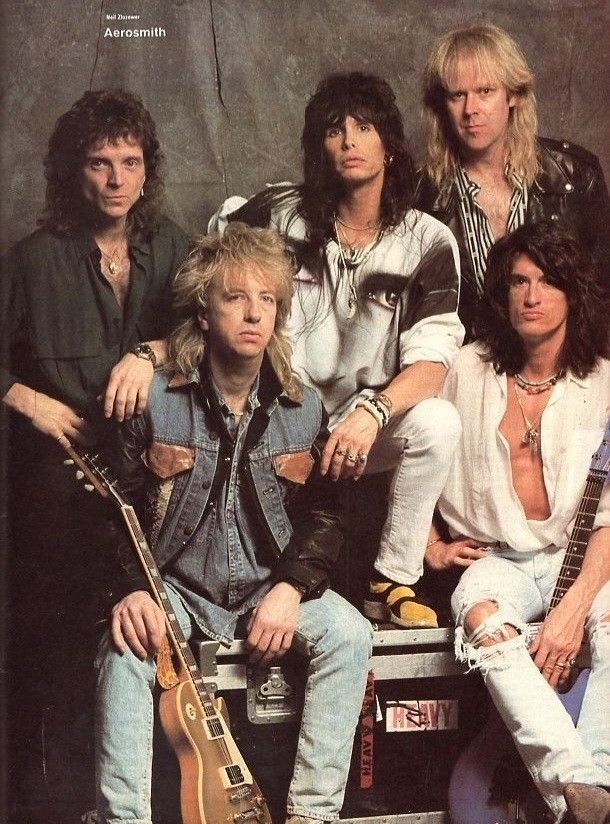 the group of young men are posing for a photo with their guitars and guitar heads