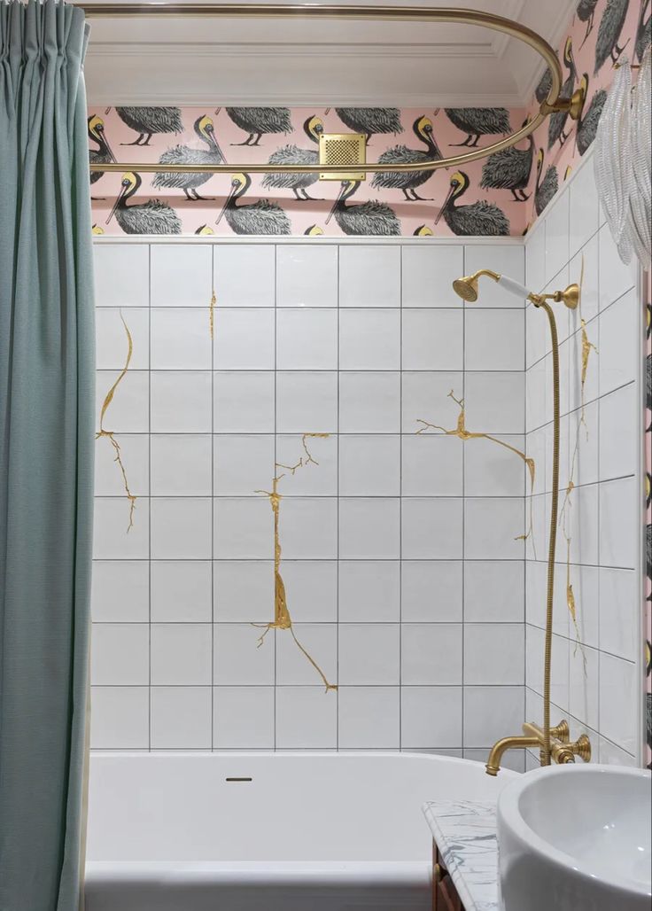 a bath room with a sink and a bath tub next to a shower curtain that has flamingos on it