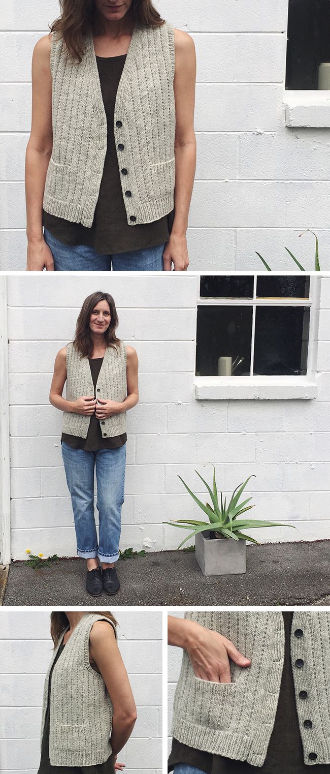 a woman standing in front of a white brick wall wearing a gray knitted vest