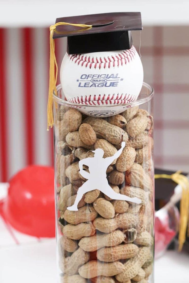 a glass jar filled with peanuts and a baseball