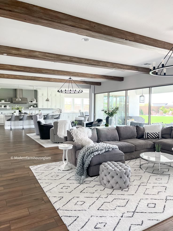 a living room filled with furniture and lots of windows