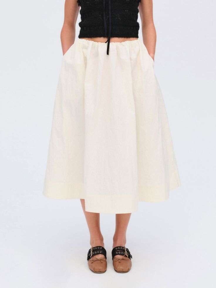 An ultra-chic transitional piece, the Billie cream midi skirt is crafted in a crisp, crinkle stretch poplin flares out into a full gathered skirt. Pair it with a contrasting colored top for a chic, seasonal look. Spring Daywear Maxi Skirt With Gathered Design, Spring Voluminous Pleated Skirt With Elastic Waistband, Chic Cream Ruffled Skirt, Chic Cream Flared Maxi Skirt, Chic Spring Gathered Maxi Skirt, Chic Gathered Spring Maxi Skirt, Chic Gathered Maxi Skirt For Spring, Off White Relaxed Skirt For Spring, Off White Relaxed Fit Skirt For Spring