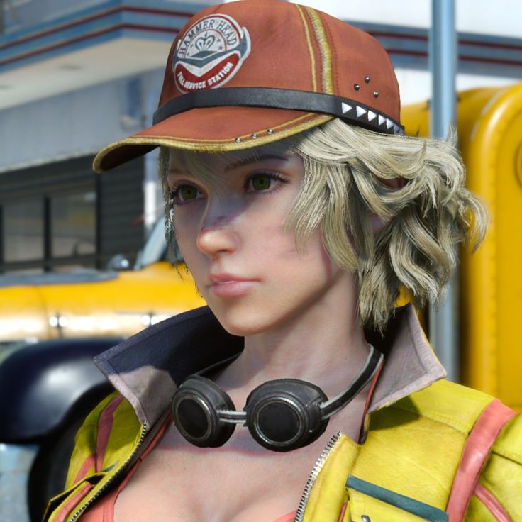 a woman with blonde hair wearing a hat and goggles in front of a yellow bus